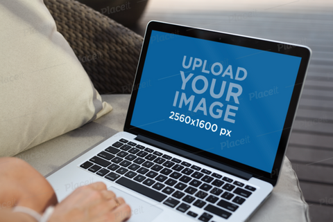 Free Mockup of a Woman Using a MacBook at Home