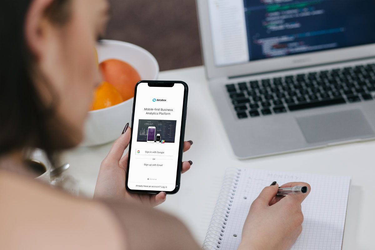 Free Woman Holding iPhone X Mockup and Taking Notes