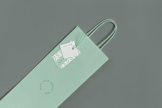 Free Flat Lay Of Paper Shopping Bag Mock-Up With Paper Tag Psd