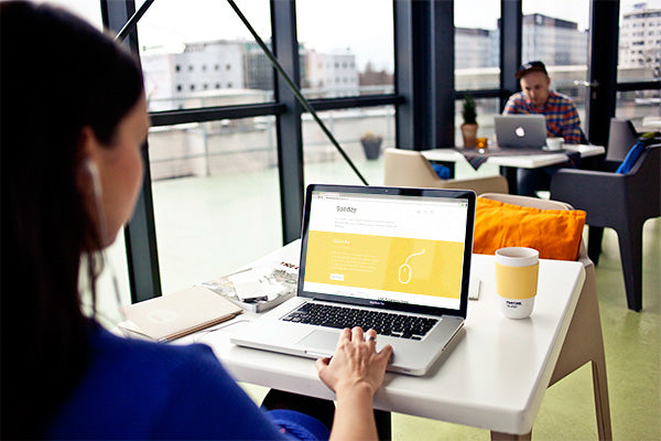 Free Women Using a Macbook Pro MockUp with Editable Screen