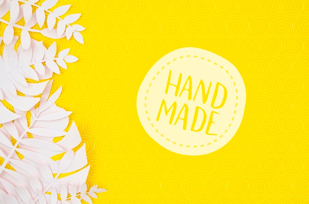 Free Handmade Badge With White Leaves On Yellow Background Psd