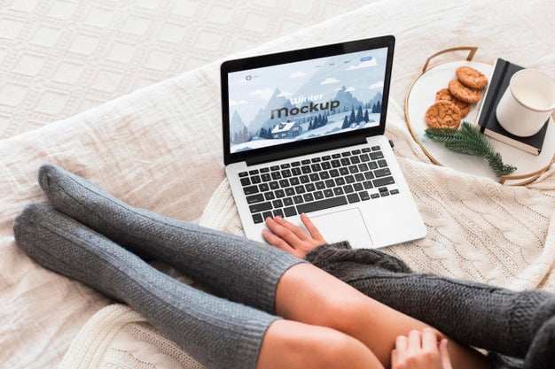 Free High Angle Woman Looking At A Laptop With Mock-Up Screen Psd