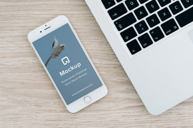 Free White iPhone 7 on Office with Empty Screen PSD Mockup