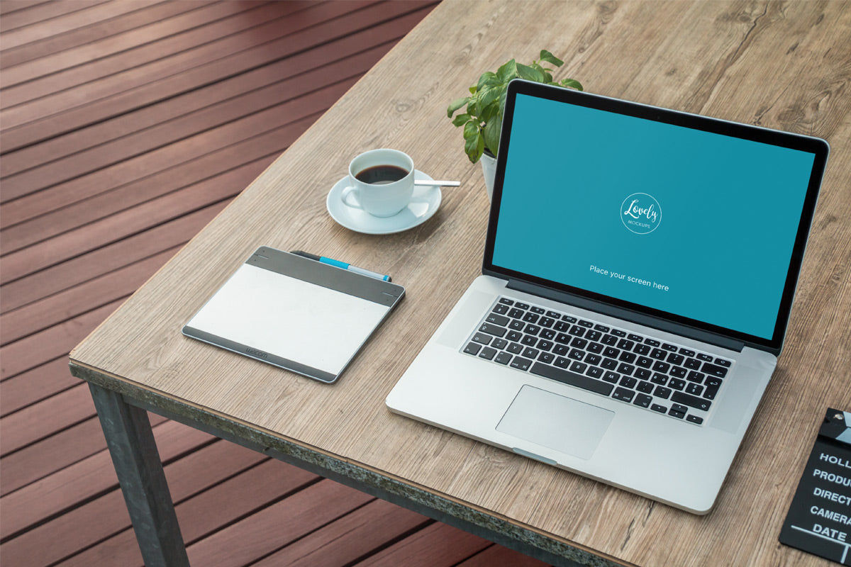 Free Macbook Next To Morning Coffee Cup Mockup Scene   CreativeBooster