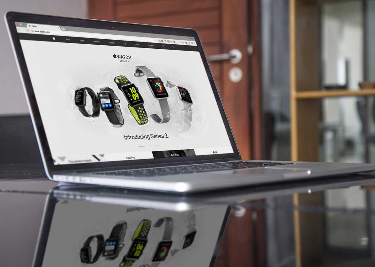 Free Apple Macbook Pro Mockup on a Glass Table Side View