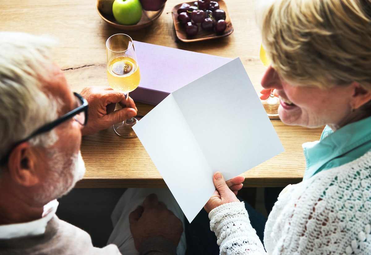 Free Senior Couple Writing On A Blank Greeting Card