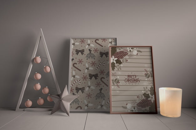 Free Set Of Paintings On Floor Beside Miniature Christmas Tree Psd