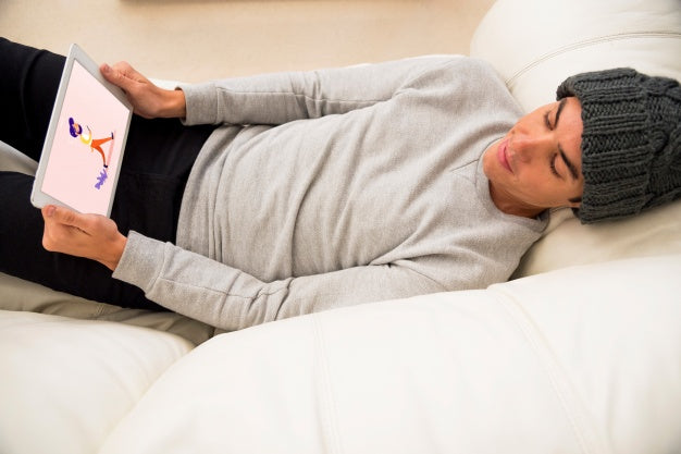Free Tablet Mockup With Man Chilling On Couch Psd
