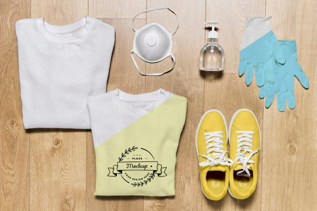 Free Top View Folded Hoodies Mock-Up With Mask And Gloves Psd