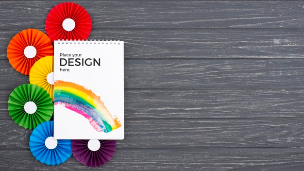 Free Top View Of Notebook With Colorful Rosettes Psd