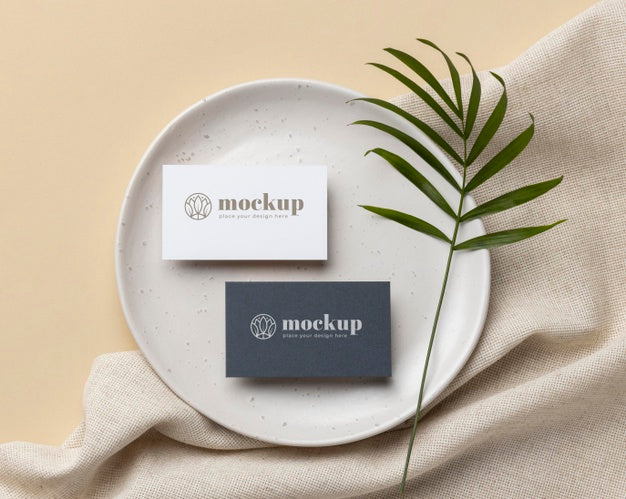 Free Top View Of Paper Stationery On Plate With Leaf Psd