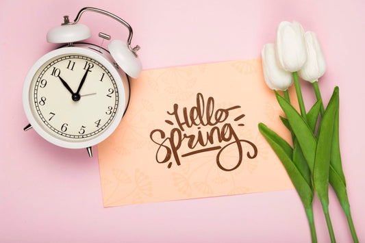 Free Top View Of Tulips With Clock And Card Psd