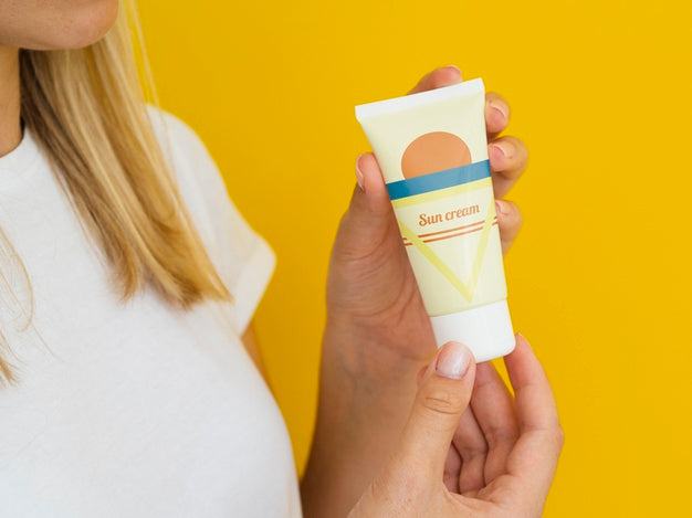 Free Woman Holding A Sun Cream Bottle Psd
