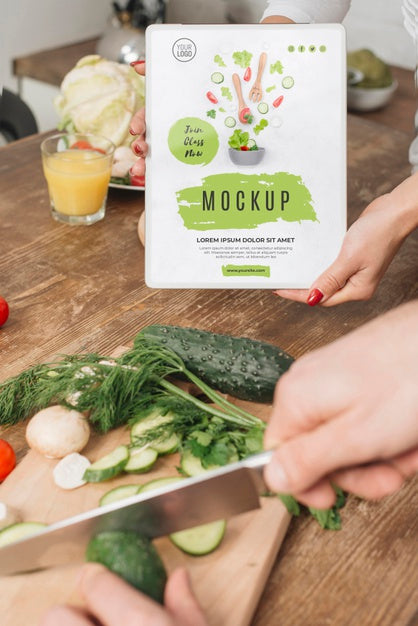 Free Woman Holding Book In The Kitchen While Man Cooks Psd