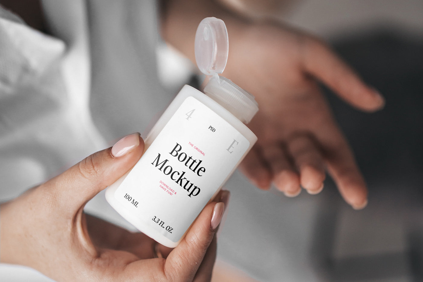 Free Women Holding Mini Bottle Mockup