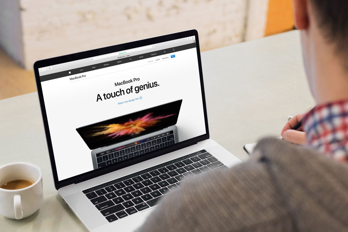 Free Young Man Working on his 15" Macbook Pro Mockup