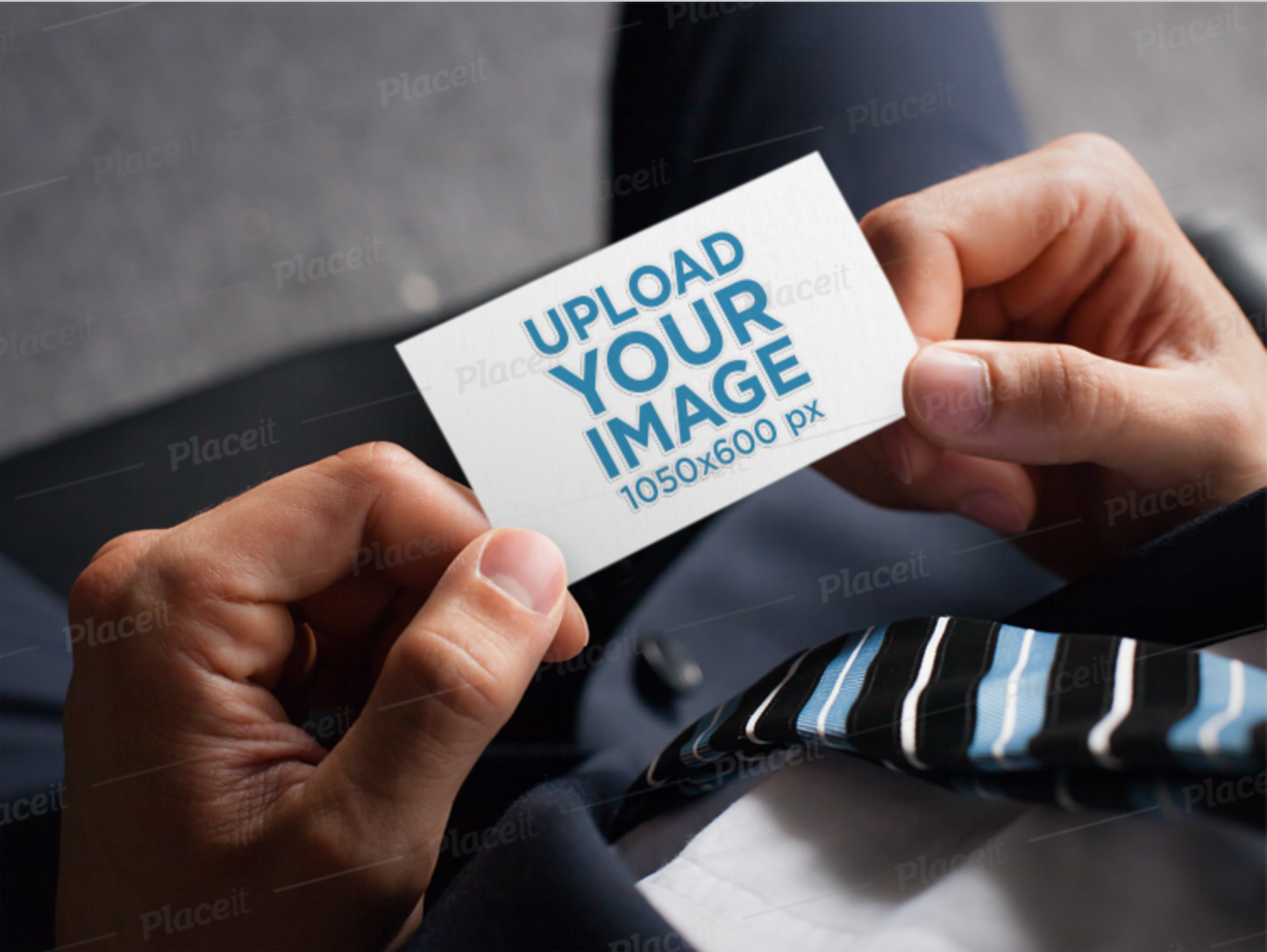 [Free to Preview] Mockup of a Man Holding a Business Card with an Embossed Texture