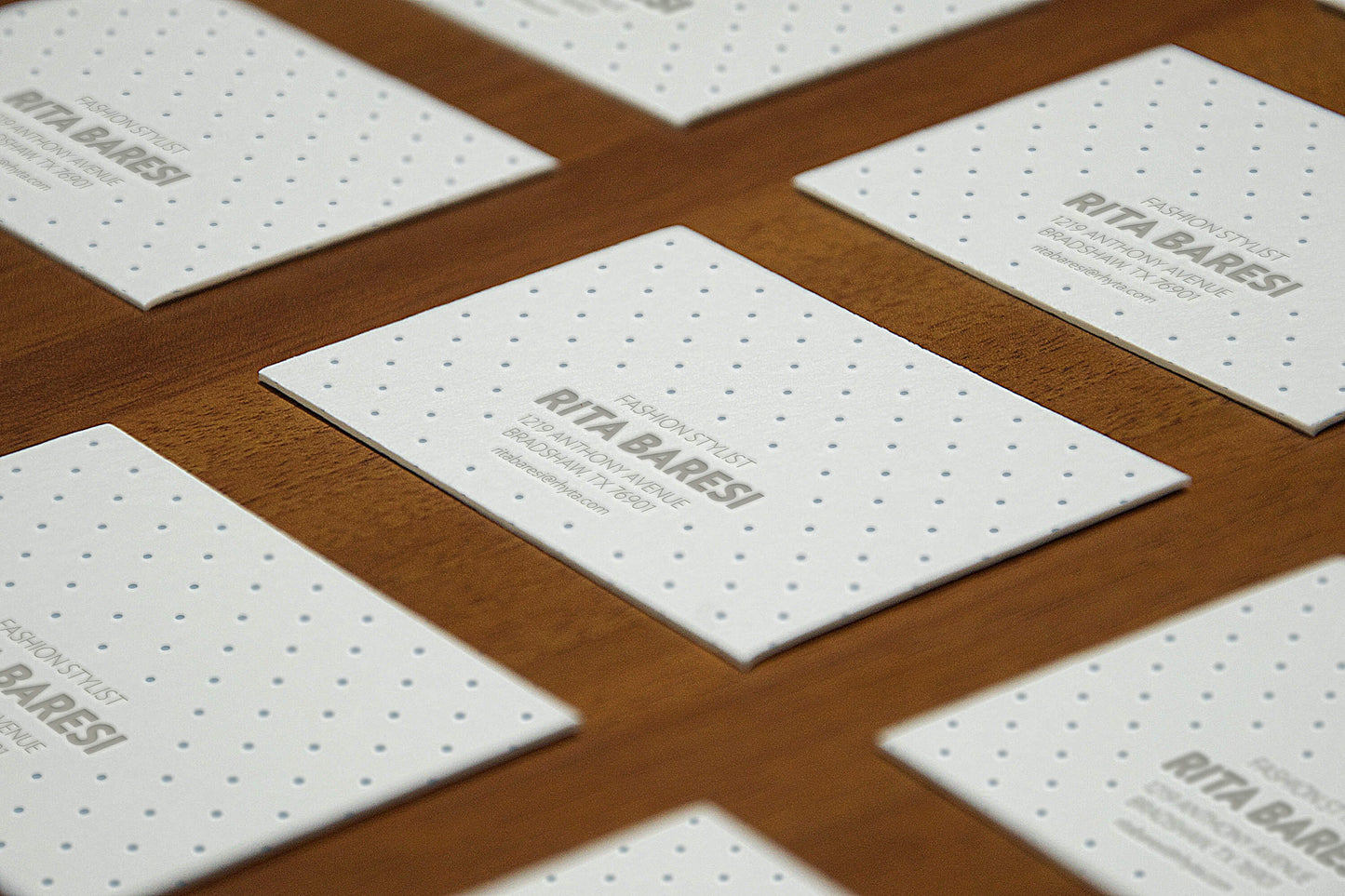 Free Perspective View of Business Cards Mockup on Wooden Surface