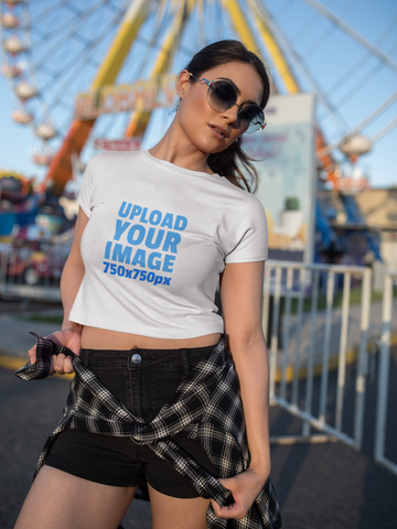White Woman Wearing a Crop Top T-Shirt Mockup at an An Amusement Park