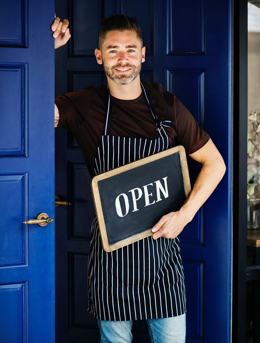 Free A Cheerful Small Business Owner With Open Sign