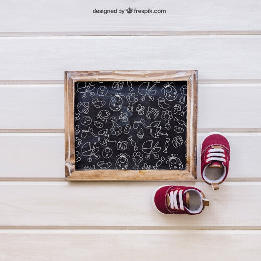 Free Baby Mockup With Slate And Little Shoes Psd