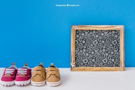 Free Baby Mockup With Slate And Two Pairs Of Shoes Psd