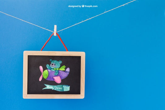 Free Baby Mockup With Slate Hanging On Clothes Peg Psd