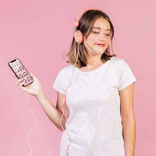 Free Beautiful Young Woman With Headphones And A Cellphone Mock-Up Psd