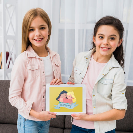 Free Best Friends Holding A Tablet Together Mock-Up Psd