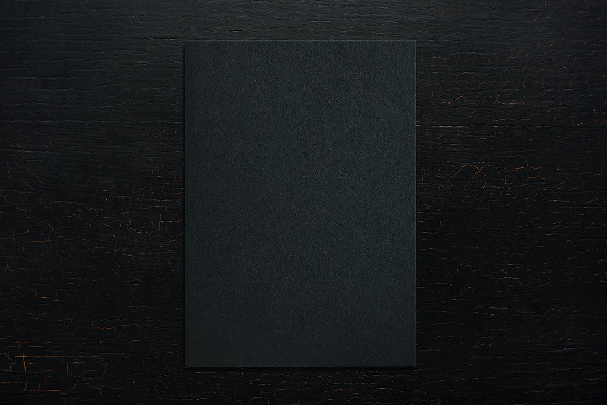 Free Black Paper On A Wooden Background
