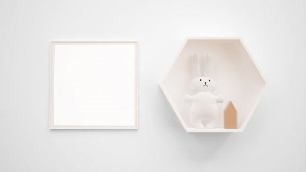 Free Blank Photo Frame Mockup Hanging On The Wall Next To A Bunny Toy Psd