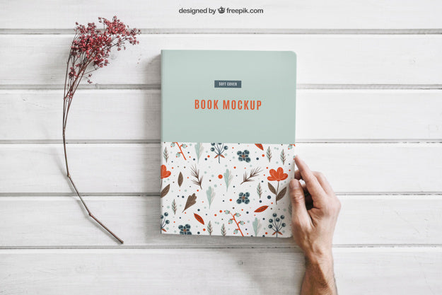 Free Book Mockup with a Flower and Hand