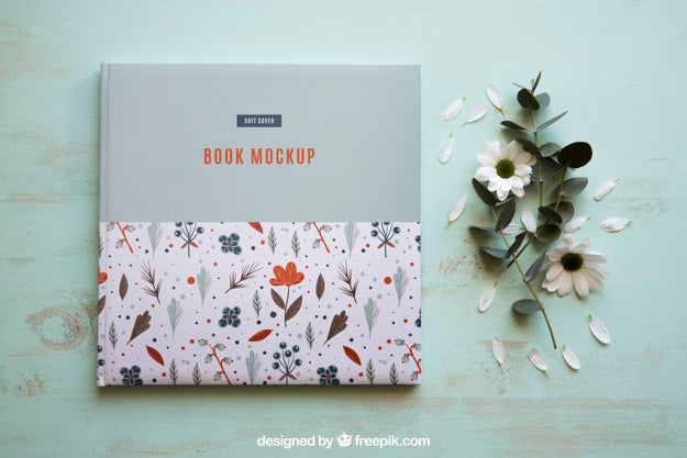 Free Book Mockup Next To Flowers Psd