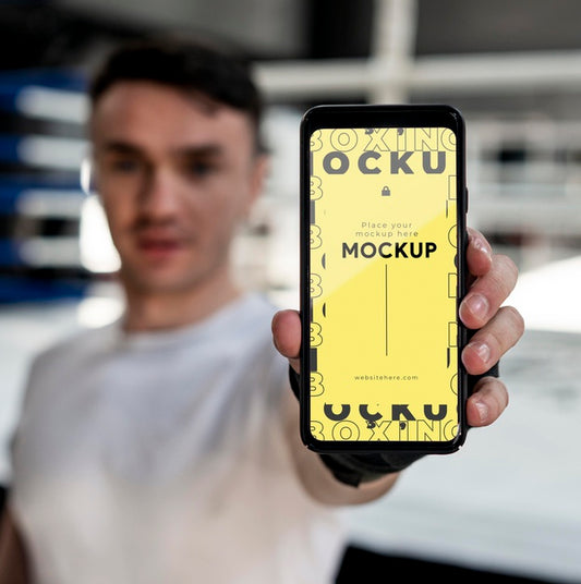 Free Boxing Athlete Holding A Mock-Up Phone Psd