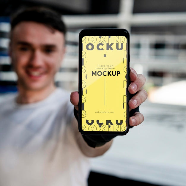 Free Boxing Athlete Holding A Mock-Up Phone Psd