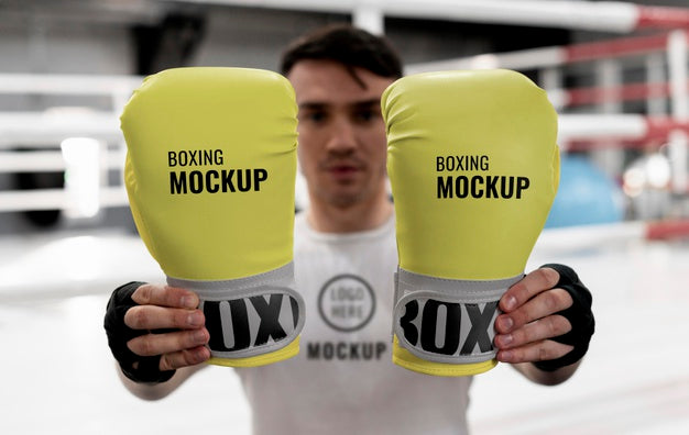 Free Boxing Athlete Holding Mock-Up Gloves To Train Psd