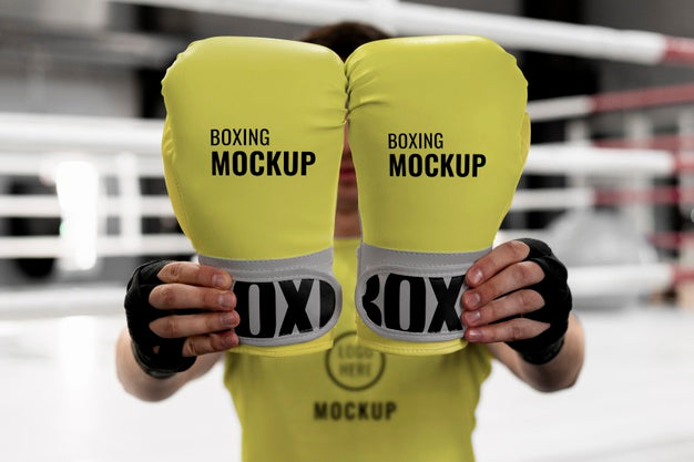 Free Boxing Athlete Holding Mock-Up Gloves To Train Psd