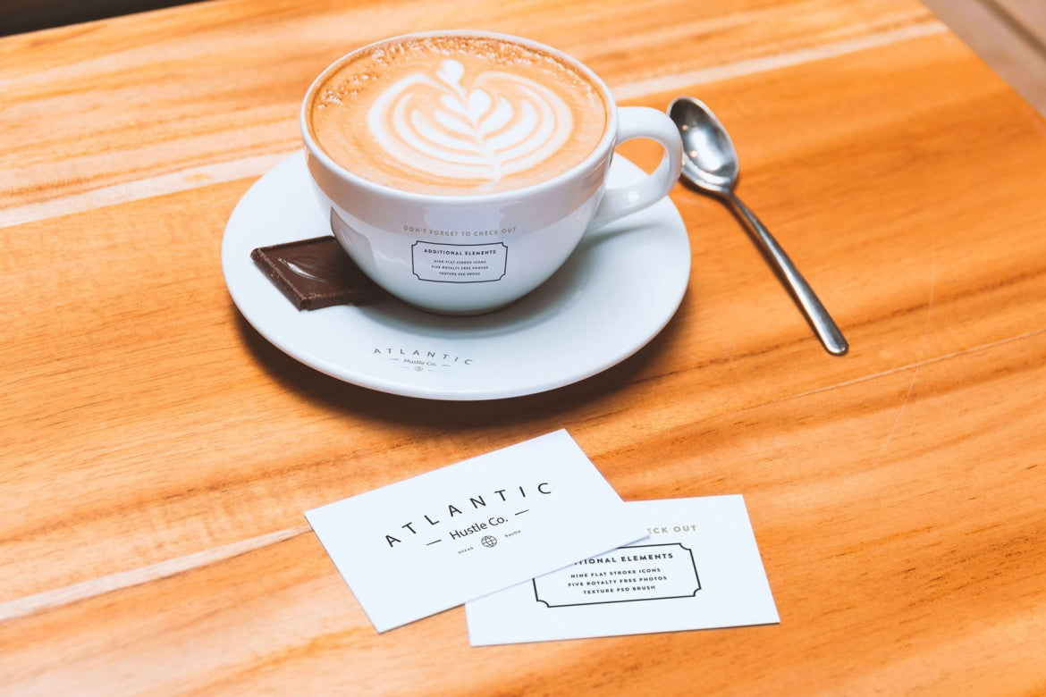 Free Business Cards and Coffee Cup on Table (Mockup)
