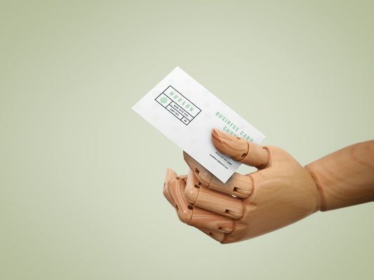 Free Business Card In Wooden Hand Mockup