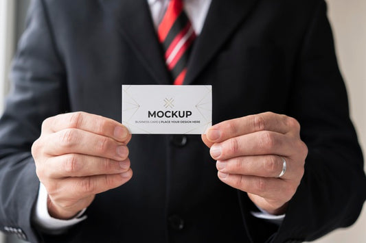 Free Businessman Holding Business Card Mock-Up With Both Hands Psd