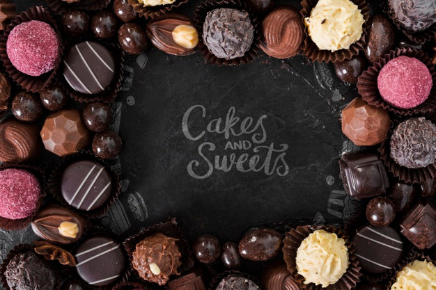 Free Cakes And Sweets Surrounded By Pralines And Candies Psd