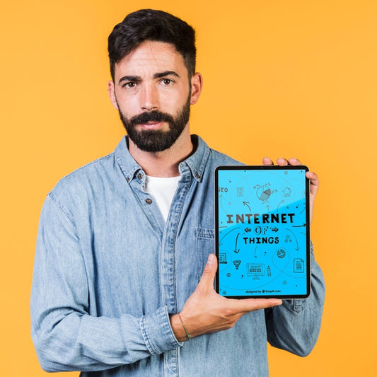 Free Casual Young Man Holding A Tablet Mock Up Psd