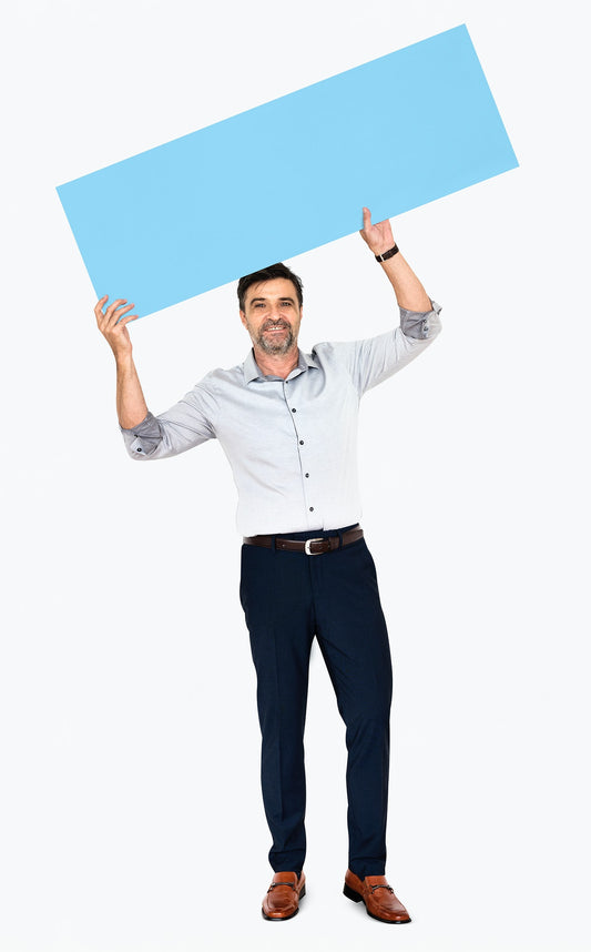 Free Cheerful Man Showing A Blank Blue Banner