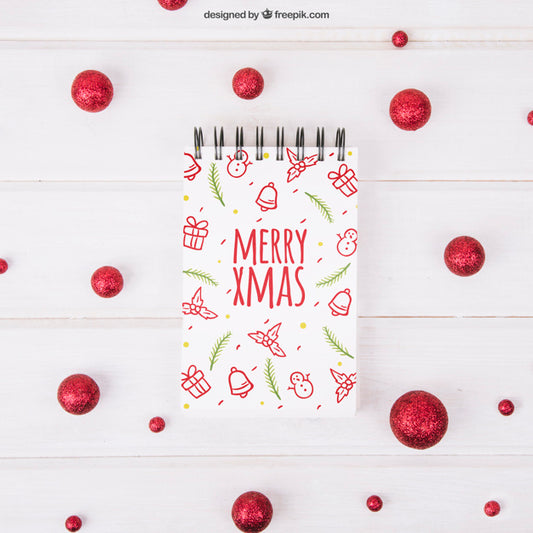 Free Christmas Mockup With Notepad And Red Balls Psd