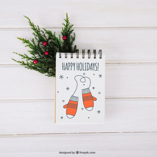 Free Christmas Mockup With Notepad On Mistletoe Branch Psd