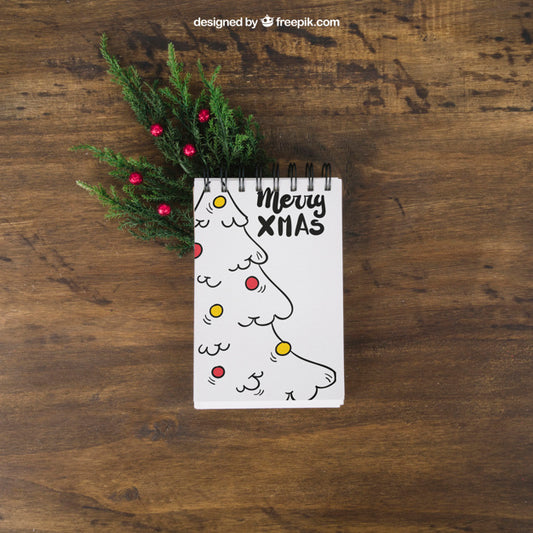 Free Christmas Mockup With Notepad On Mistletoe Psd