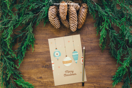 Free Christmas Mockup With Pine Cones And Greeting Card Psd