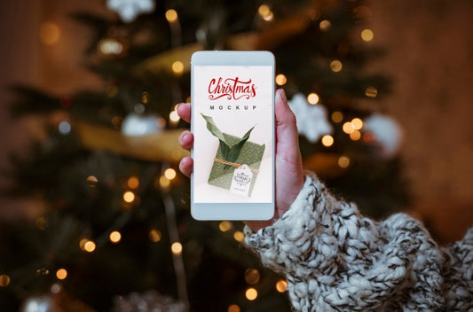 Free Christmas Sale Mockup With Hand Holding Smartphone Psd
