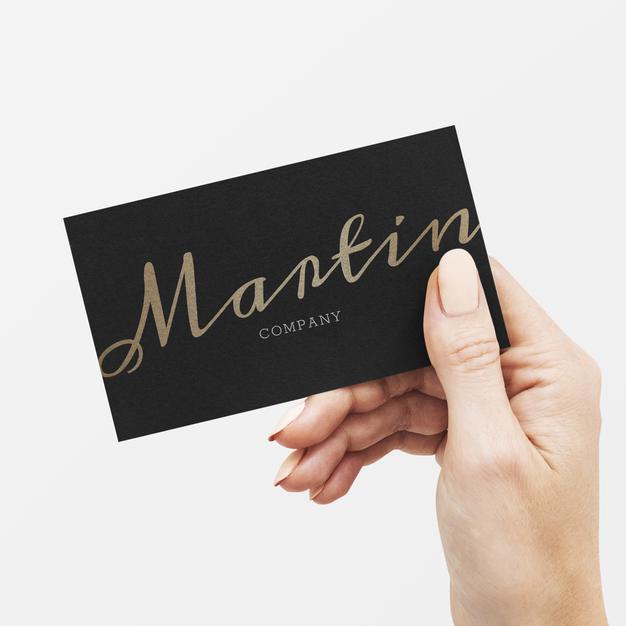 Free Classy Business Card In Black And Gold In A Hand Psd