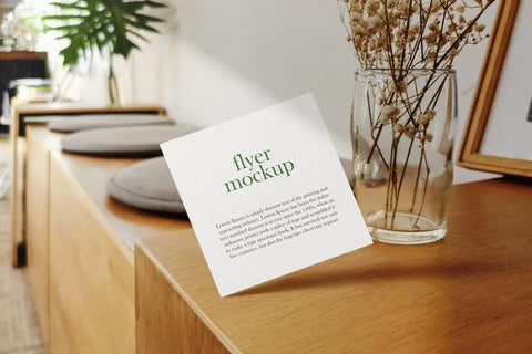 Free Clean Minimal Square Flyer Mockup Floating On Wooden Top With Glass Vase. Psd File. Psd